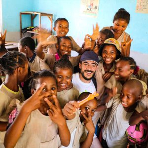 Volunteer teacher with african children in classroom